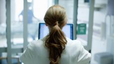 Healthcare working looking at computer screen